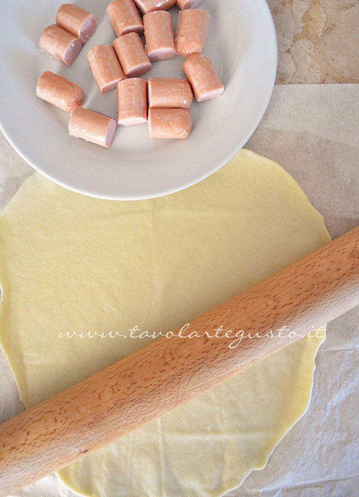 Tagliare a pezzetti i wurstel - Ricetta Rotolini di Wurstel in brisee Tagliare a pezzetti i wurstel - Ricetta Rotolini di Wurstel in brisee