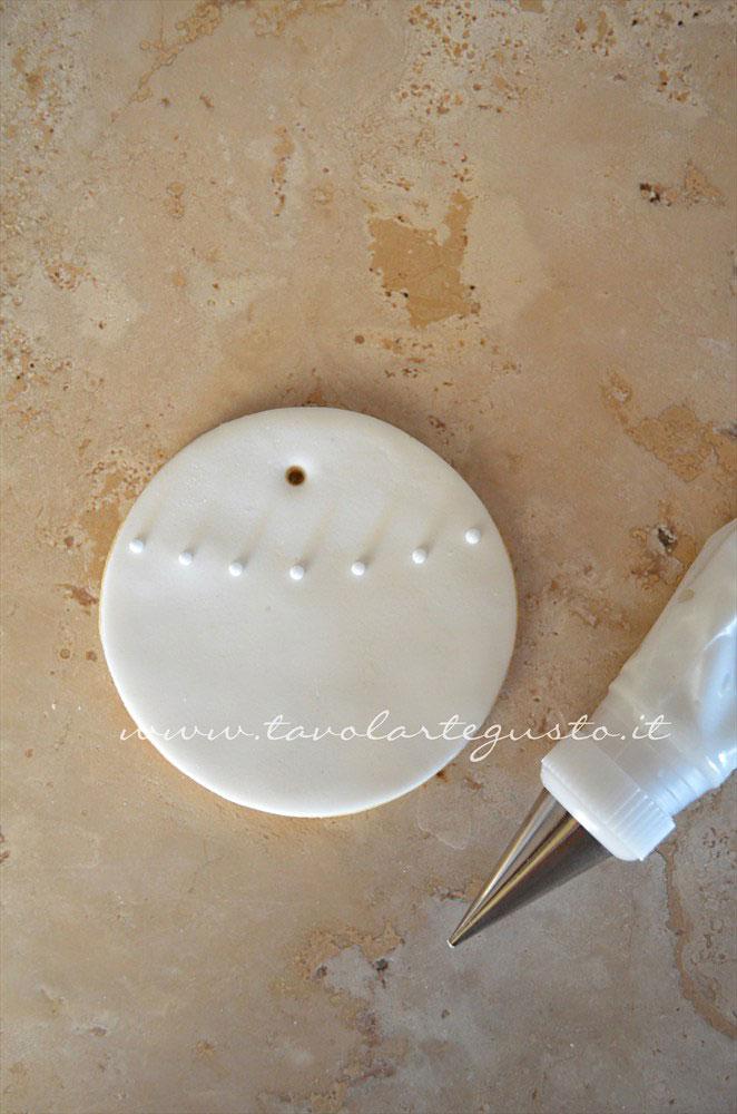Realizzare un giro di pois di ghiaccia poco sopra la metà del biscotto -Ricetta Biscotti di Natale decorati in Pasta di Zucchero Realizzare un giro di pois di ghiaccia poco sopra la metà del biscotto -Ricetta Biscotti di Natale decorati in Pasta di Zucchero