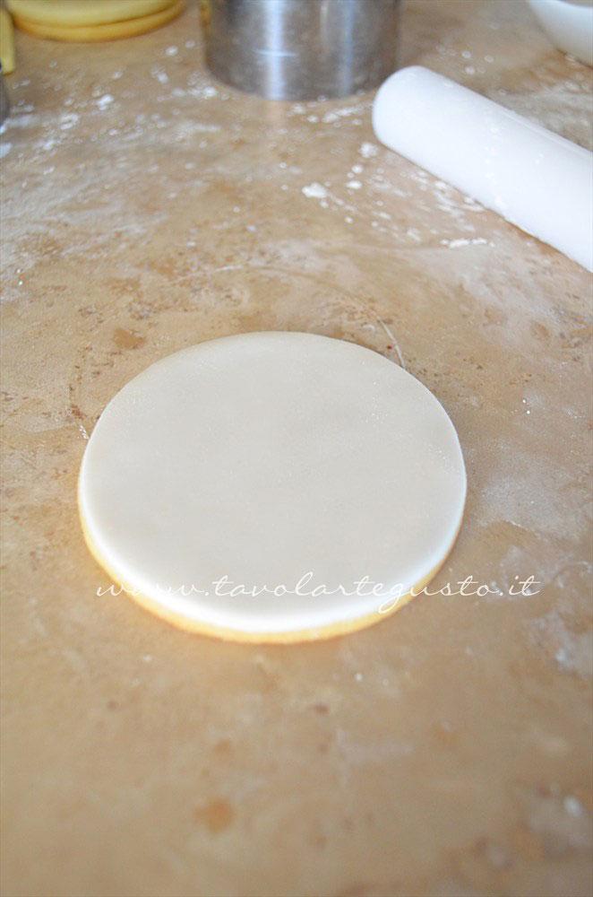 Ricoprire il biscotto con la pasta di zucchero intagliata - Ricetta Biscotti di Natale decorati in Pasta di Zucchero Ricoprire il biscotto con la pasta di zucchero intagliata - Ricetta Biscotti di Natale decorati in Pasta di Zucchero