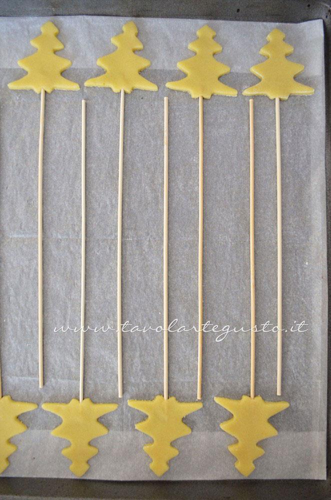Disporre i biscotti su stecco nella teglia - Ricetta Biscotti lecca lecca natalizi (Christmas Cookies pops) Disporre i biscotti su stecco nella teglia - Ricetta Biscotti lecca lecca natalizi (Christmas Cookies pops)