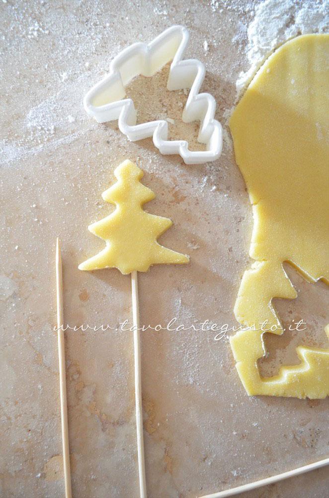 Infilare le stecche nei biscotti - Ricetta Biscotti lecca lecca natalizi (Christmas Cookies pops) Infilare le stecche nei biscotti - Ricetta Biscotti lecca lecca natalizi (Christmas Cookies pops)