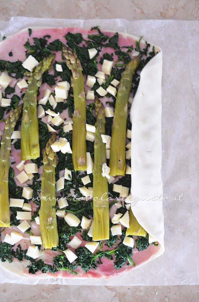 Aggiungere il formaggio a cubetti e arrotolare la sfoglia - Ricetta Strudel di verdure Aggiungere il formaggio a cubetti e arrotolare la sfoglia - Ricetta Strudel di verdure