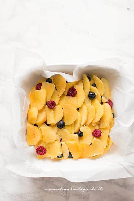 Aggiungere le pesche affettate - Ricetta Torta Crumble alla frutta (pesche e mirtilli)
