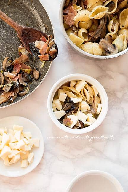 Riempire le pirofile - Ricetta pasta al forno con funghi e speck