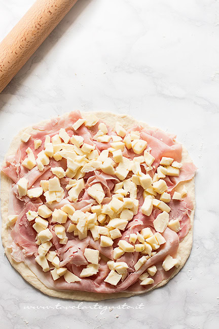 Stendere l'impasto e farcire - Ricetta Focaccia in padella