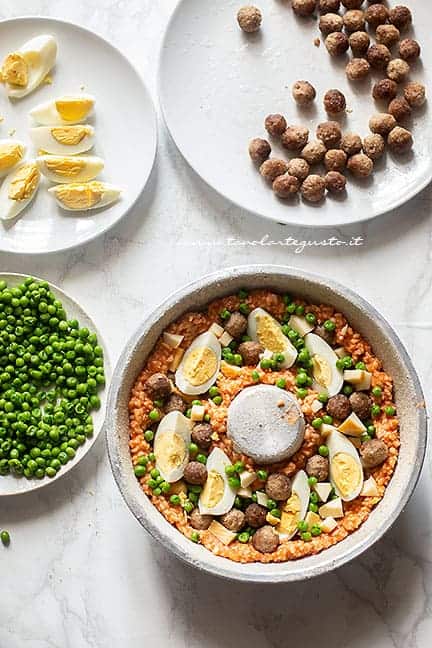 aggiungere piselli, uova sode, polpettine- Ricetta Sartù di riso